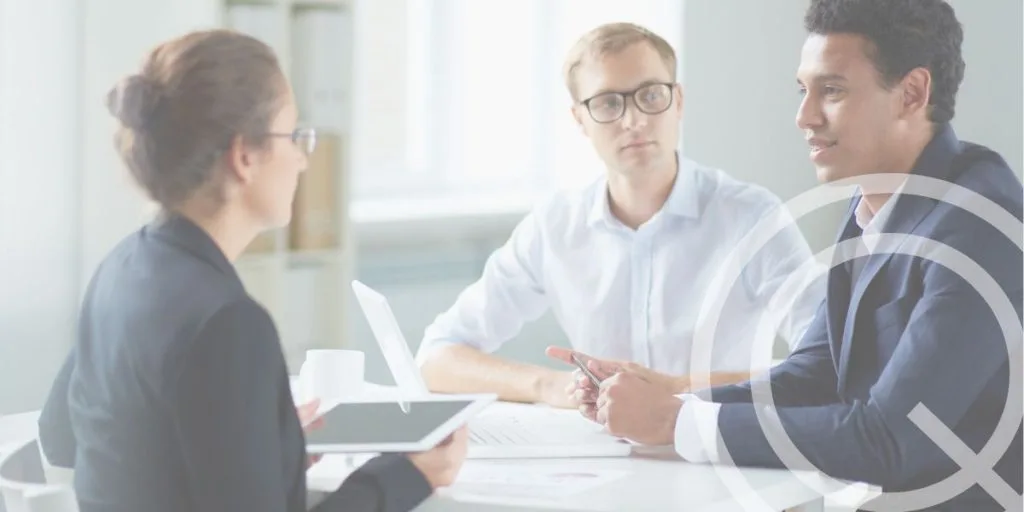 Two men and a woman in a seated interview setting.